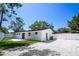 Exterior view of home with spacious backyard, white fence, and gravel parking at 5698 26Th N Ave, St Petersburg, FL 33710
