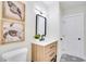 Bathroom featuring a new vanity, modern faucet, decorative mirror, and stylish tile floor at 5698 26Th N Ave, St Petersburg, FL 33710