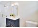 Modern bathroom with a glass enclosed shower, blue vanity, and gold fixtures at 5698 26Th N Ave, St Petersburg, FL 33710
