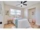 Comfortable bedroom with wood floors, ceiling fan, and natural light from the window at 5698 26Th N Ave, St Petersburg, FL 33710