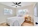Bright bedroom features wood floors, ceiling fan, and natural light from two windows at 5698 26Th N Ave, St Petersburg, FL 33710