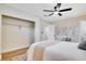 Bedroom with light walls, a ceiling fan, and a comfortable queen bed with bench at 5698 26Th N Ave, St Petersburg, FL 33710
