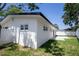 The exterior of the home with new white paint, new black roof, and green grass at 5698 26Th N Ave, St Petersburg, FL 33710