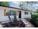 Charming front entrance with accent chairs, decorative tile, and colorful landscaping at 5698 26Th N Ave, St Petersburg, FL 33710