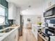 Open kitchen with stainless steel appliances, quartz countertops, an island, and an adjoining dining room at 5698 26Th N Ave, St Petersburg, FL 33710