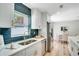 Updated kitchen with stainless steel appliances, white cabinets, and blue tile backsplash at 5698 26Th N Ave, St Petersburg, FL 33710