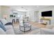 Spacious living room with hardwood floors, modern furnishings, and seamless flow to kitchen and dining areas at 5698 26Th N Ave, St Petersburg, FL 33710