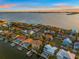 Expansive waterfront homes featuring a mix of coastal charm and modern luxury at sunset at 5964 Bayview S Cir, St Petersburg, FL 33707