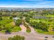 An aerial view captures the elegant entrance to a neighborhood featuring a golf course and lake at 5964 Bayview S Cir, St Petersburg, FL 33707