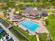 Aerial view featuring a pool, clubhouse, marina, and waterfront access with stunning views at 5964 Bayview S Cir, St Petersburg, FL 33707