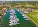 An aerial view shows the marina and boat docks along with the golf course and clubhouse at 5964 Bayview S Cir, St Petersburg, FL 33707
