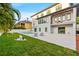 Expansive backyard with a modern patio, refreshing pool, lush lawn and elegant lounge chairs at 5964 Bayview S Cir, St Petersburg, FL 33707