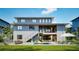 Contemporary home with outdoor pool, patio, lounge chairs, dining, and manicured lawn at 5964 Bayview S Cir, St Petersburg, FL 33707