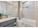 Bathroom with vanity, toilet and tub/shower combo with frameless glass doors and decorative mirror at 5964 Bayview S Cir, St Petersburg, FL 33707