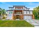 Beautiful modern home with a two-car garage, striking balconies, and manicured landscaping at 5964 Bayview S Cir, St Petersburg, FL 33707