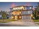 Contemporary two-story home with balconies, manicured lawn, and a spacious driveway at 5964 Bayview S Cir, St Petersburg, FL 33707