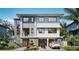 Contemporary two-story home featuring a stone facade, a two-car garage, and manicured landscaping at 5964 Bayview S Cir, St Petersburg, FL 33707