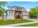 Impressive modern three-story home with balconies, a two-car garage, and well-kept landscaping at 5964 Bayview S Cir, St Petersburg, FL 33707