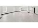 Open garage space featuring epoxy floors, natural light, and black trim at 5964 Bayview S Cir, St Petersburg, FL 33707