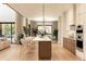 Open-concept kitchen with an island, seating, stainless steel appliances, and natural light at 5964 Bayview S Cir, St Petersburg, FL 33707