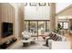 Spacious living room with high ceilings, large windows, and stylish contemporary furniture at 5964 Bayview S Cir, St Petersburg, FL 33707