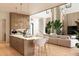 Open-concept living room and kitchen with modern finishes, hardwood floors, and ample natural light, blending luxury and comfort at 5964 Bayview S Cir, St Petersburg, FL 33707