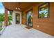 Covered patio with wood ceiling, fan, stylish door and neutral tile flooring at 5964 Bayview S Cir, St Petersburg, FL 33707