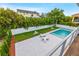 Backyard with a sparkling pool, lounge chairs, and lush landscaping, offering a private outdoor oasis at 5964 Bayview S Cir, St Petersburg, FL 33707