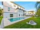 Enjoy outdoor living with this stylish pool, patio, green lawn and decorative rock feature at 5964 Bayview S Cir, St Petersburg, FL 33707