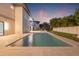 View of backyard pool with travertine pavers, adjacent to the house, with privacy landscaping and fence at 5964 Bayview S Cir, St Petersburg, FL 33707