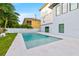 Sparkling swimming pool area with a lush green lawn and view of the modern home exterior at 5964 Bayview S Cir, St Petersburg, FL 33707