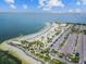 Gorgeous aerial view of the community beach featuring white sand, palm trees, and ample parking at 600 Banana St, Tarpon Springs, FL 34689