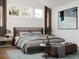 Beautifully staged main bedroom with ensuite, featuring neutral colors and modern design at 600 Banana St, Tarpon Springs, FL 34689