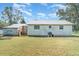 Back exterior of home with detached outbuilding and metal roof at 6118 Kracker Ave, Gibsonton, FL 33534