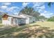 View of the backyard featuring a partial home view and detached storage shed at 6118 Kracker Ave, Gibsonton, FL 33534