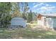 Lush backyard with a storage shed, outbuilding, and grassy lawn at 6118 Kracker Ave, Gibsonton, FL 33534