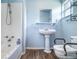 Cozy bathroom with pedestal sink, modern toilet, and tub with shower at 6118 Kracker Ave, Gibsonton, FL 33534