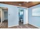 Bedroom view with a bathroom entrance featuring a sliding barn door at 6118 Kracker Ave, Gibsonton, FL 33534