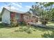 Inviting home with a blend of brick and siding, highlighted by a ramp and lush greenery at 6118 Kracker Ave, Gibsonton, FL 33534