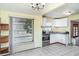 Well-lit kitchen area with white cabinets and stainless steel appliances near the dining area at 6118 Kracker Ave, Gibsonton, FL 33534