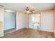 Open living area leading to kitchen, with hardwood floors, ceiling fan, and a modern design at 6118 Kracker Ave, Gibsonton, FL 33534
