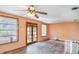 Bright living room featuring hardwood floors, ceiling fan and natural light through windows at 6118 Kracker Ave, Gibsonton, FL 33534