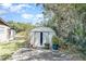 Metal shed on a concrete foundation, nestled among lush greenery at 6118 Kracker Ave, Gibsonton, FL 33534