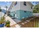 Backyard of the house with a stone path and tropical plants at 616 2Nd St, Indian Rocks Beach, FL 33785
