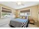 Tranquil bedroom featuring two windows with blinds, and essential furnishings for a relaxing and private atmosphere at 616 2Nd St, Indian Rocks Beach, FL 33785