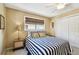 Cozy bedroom showcasing a neatly made bed, window with blinds, and essential furnishings for a comfortable stay at 616 2Nd St, Indian Rocks Beach, FL 33785