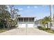 Charming home with a screened-in porch, two-car garage, and driveway at 616 2Nd St, Indian Rocks Beach, FL 33785