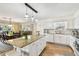Bright kitchen with white cabinets and granite island open to the dining room at 616 2Nd St, Indian Rocks Beach, FL 33785