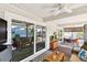 Inviting covered porch featuring comfortable seating and a dining area with a ceiling fan at 616 2Nd St, Indian Rocks Beach, FL 33785