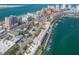 Elevated aerial view of a waterfront condo community with boat docks, close to local amenities at 640 Bayway Blvd # 302, Clearwater Beach, FL 33767